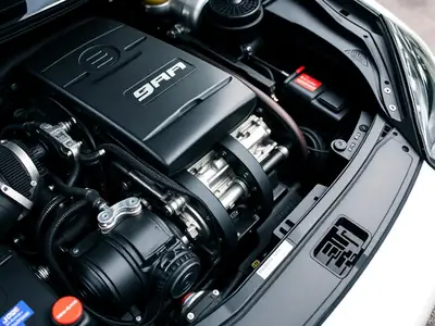 Close-up of a car engine bay with intake components